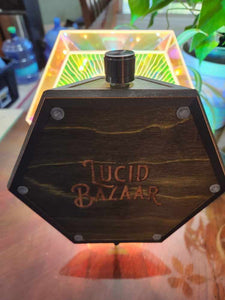 Bottom of the Boletus Lumos lamp, tilted to show the artists inscription reading The Lucid Bazaar Company