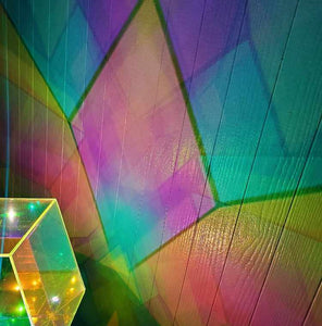 Close up image of the color patterns of the Starfield lamp, which are rainbow patterns with darker shadows between them, and the lamp itself which appears to be a field of stars